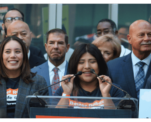 Student speaking to public during press event announcing the submission of over 32,000 signatures to advance Better Roads Safe Streets transportation measure toward November ballot