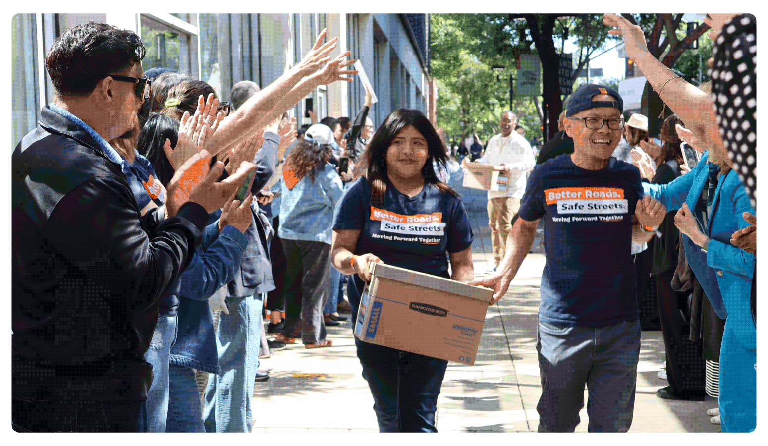 Youth and volunteers walks one of fifteen boxes comprising of the 32,000 signatures collected by Better Roads, Safe Streets to advance the Better Roads, Safe Streets transportation measure