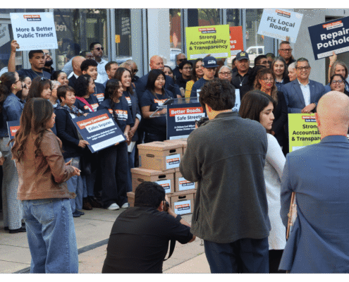 Student speaking to public during press event announcing the submission of over 32,000 signatures to advance Better Roads Safe Streets transportation measure toward November ballot