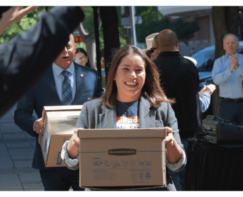 Veronica Garibay walks one of fifteeen boxes comprising of the 32,000 signatures collected by Better Roads, Safe Streets to advance the Better Roads, Safe Streets transportation measure