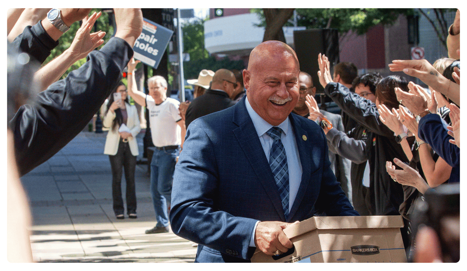 Mayor of Fresno Jerry Dyer walks one of fifteen boxes comprising of the 32,000 signatures collected by Better Roads, Safe Streets to advance the Better Roads, Safe Streets transportation measure