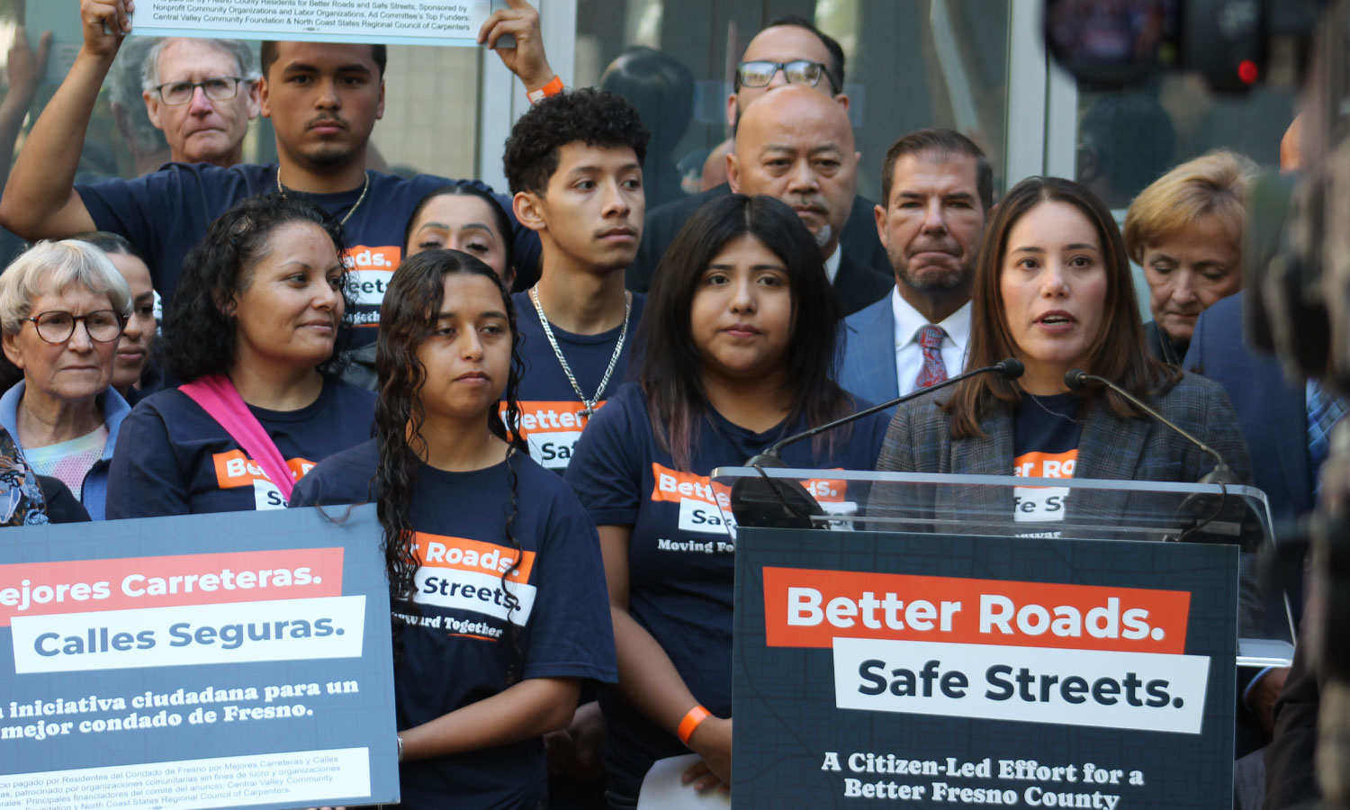 Veronica Garibay speaking to public during press event announcing the submission of over 32,000 signatures to advance Better Roads Safe Streets transportation measure toward November ballot
